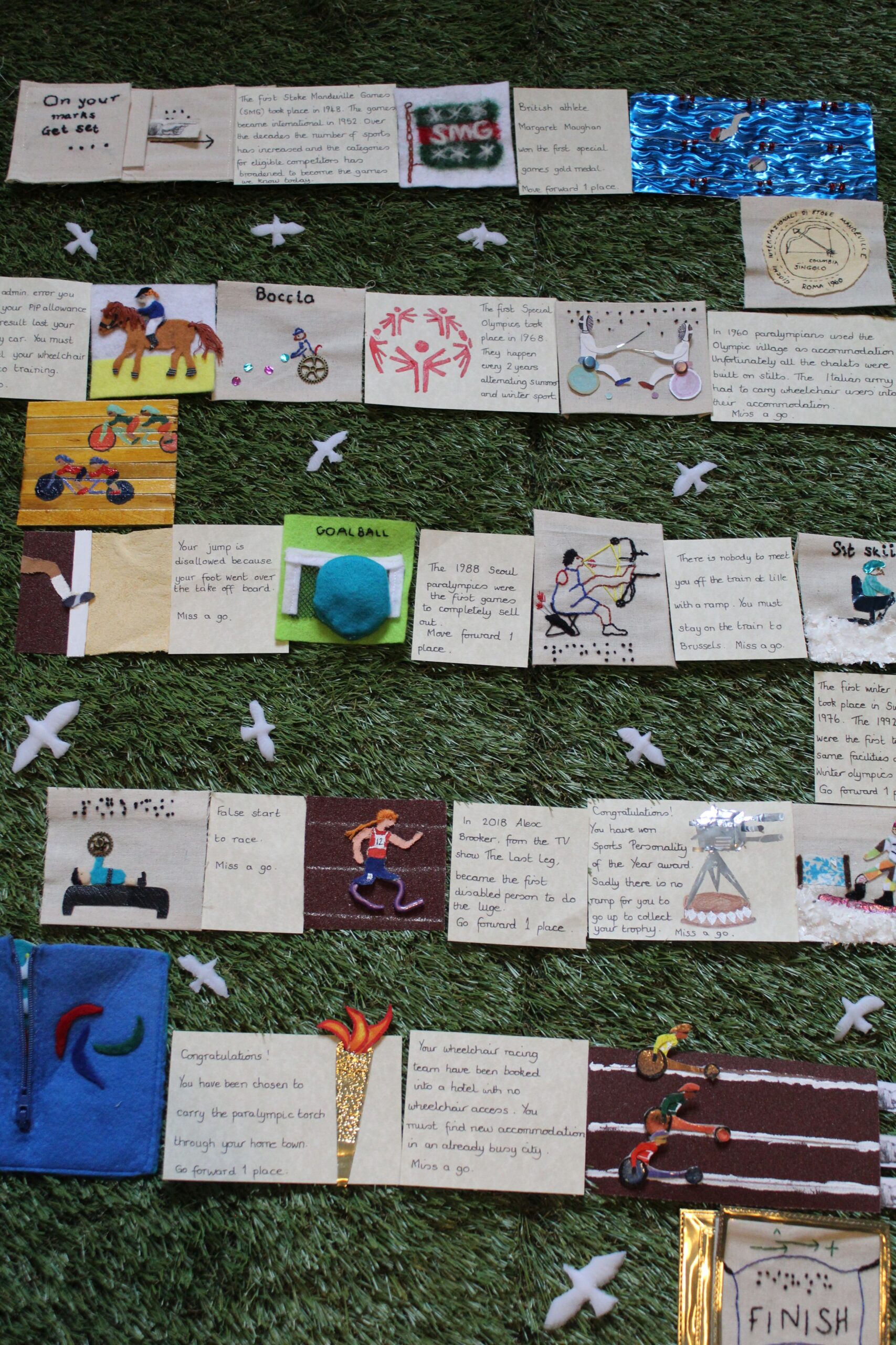 Full layout of an interactive game made from embroidered and embellished squares